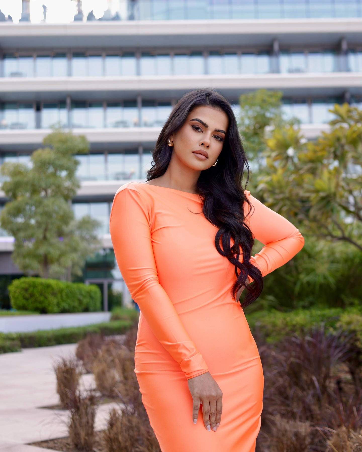 Sharmiela Mandre looks stunning in a body-hugging, floor-length, peach-orange gown with full sleeves and an open back. Sharmiela Mandre looks stunning in a body-hugging, floor-length, peach-orange gown with full sleeves and an open back.