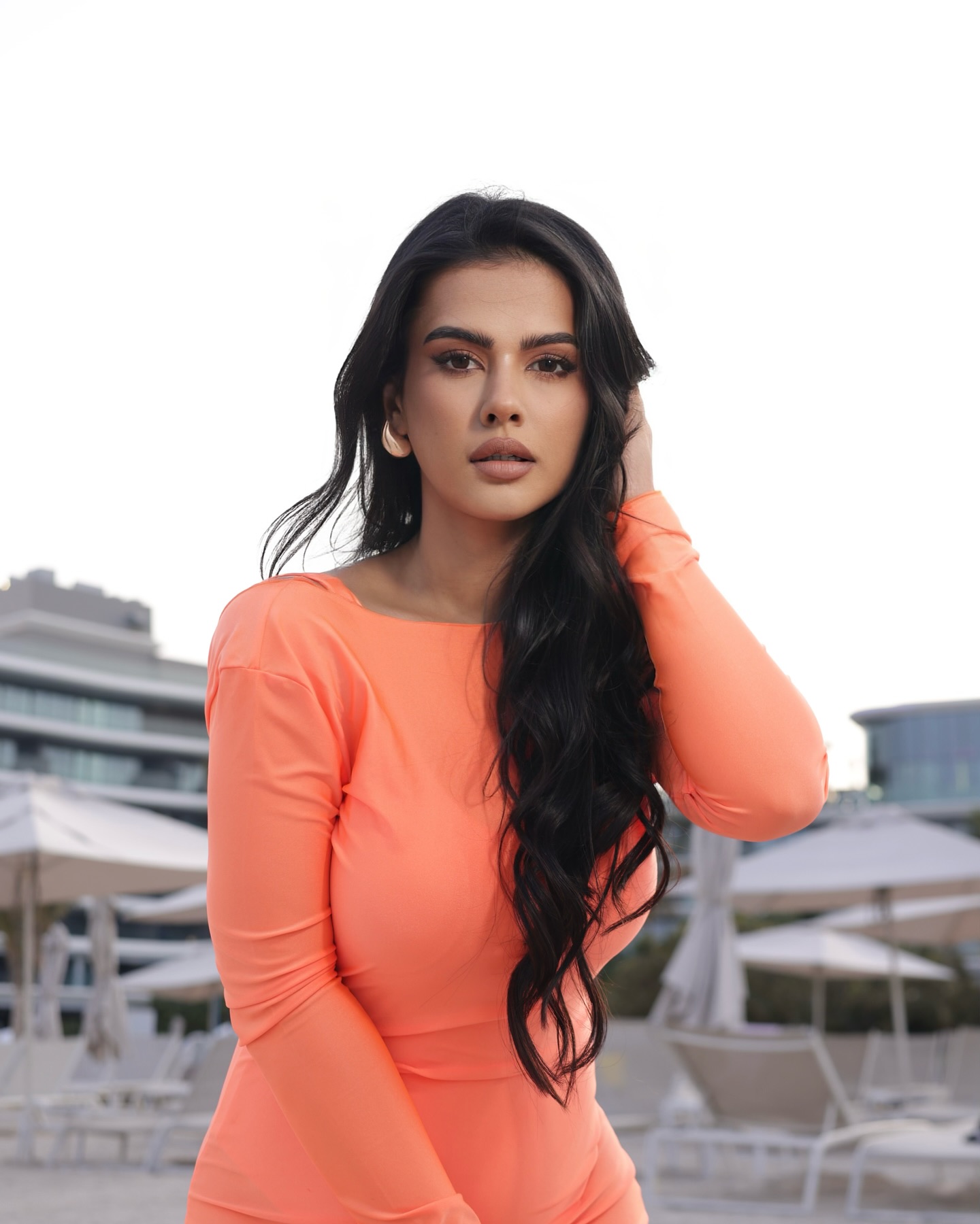 Sharmiela Mandre looks stunning in a body-hugging, floor-length, peach-orange gown with full sleeves and an open back. Sharmiela Mandre looks stunning in a body-hugging, floor-length, peach-orange gown with full sleeves and an open back.