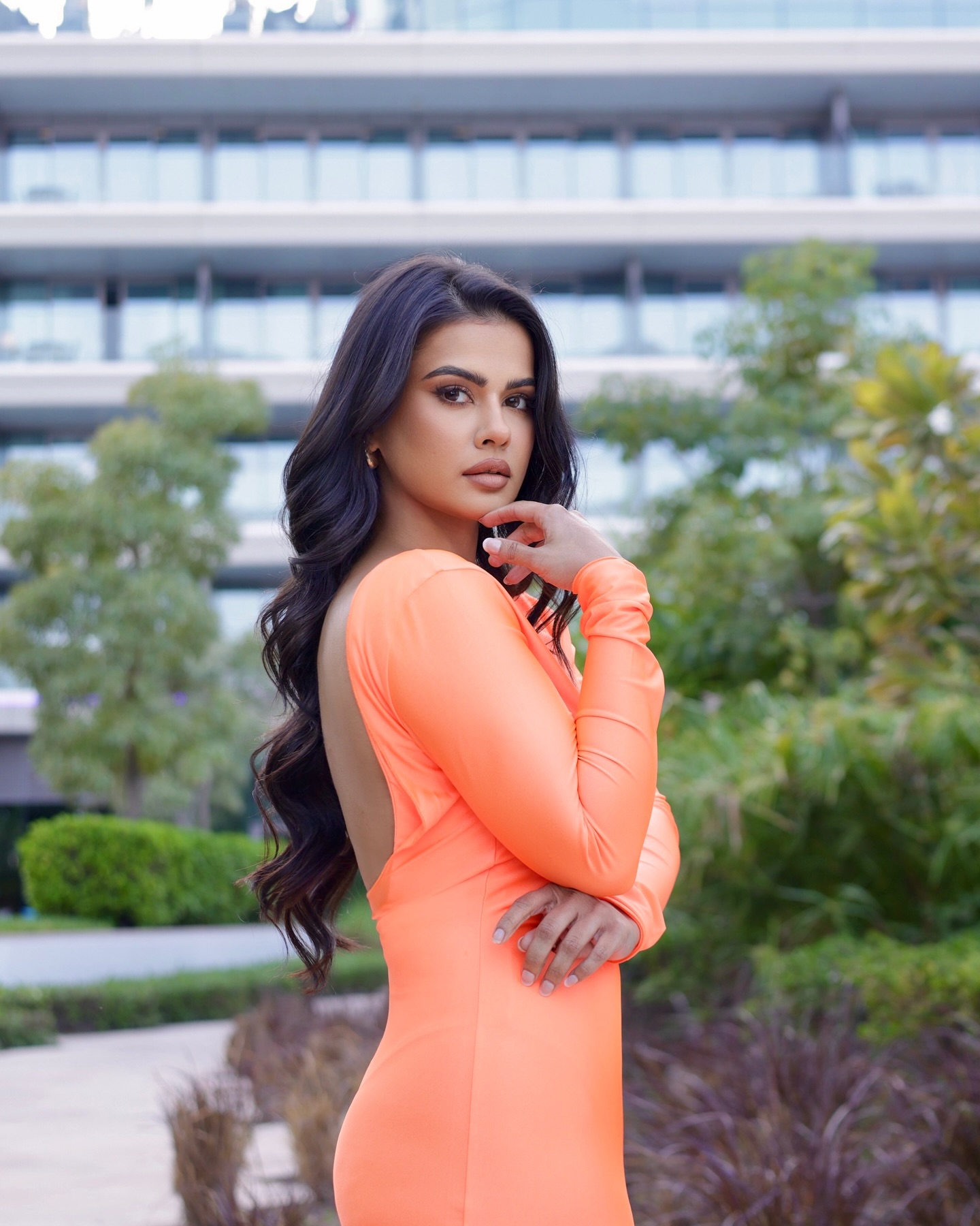 Sharmiela Mandre looks stunning in a body-hugging, floor-length, peach-orange gown with full sleeves and an open back. Sharmiela Mandre looks stunning in a body-hugging, floor-length, peach-orange gown with full sleeves and an open back.